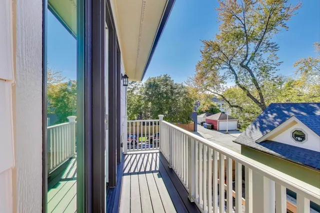 a view of a balcony with wooden fence and floor