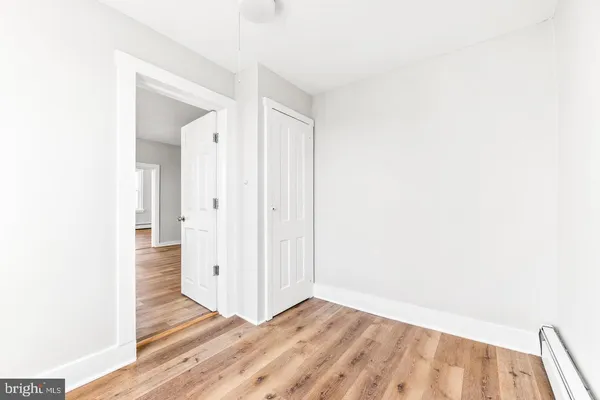 a view of a hallway with wooden floor