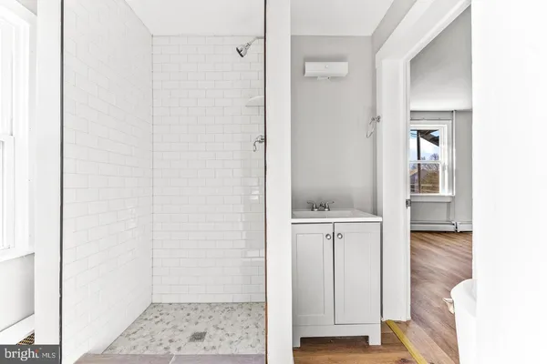 a view of bathroom with a sink and mirror
