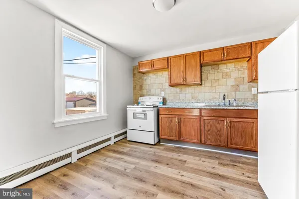 a view of a kitchen with a sink cabinets and a window