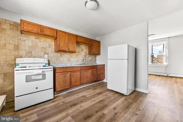 a kitchen with a refrigerator sink stove and cabinets