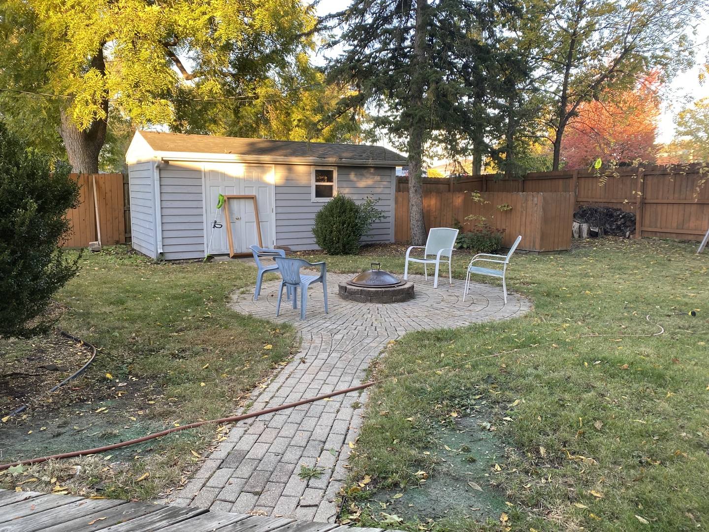 10 Briar Lane Geneva, IL 60134 - Photo 23 of 35 a view of backyard with table and chairs and wooden fence