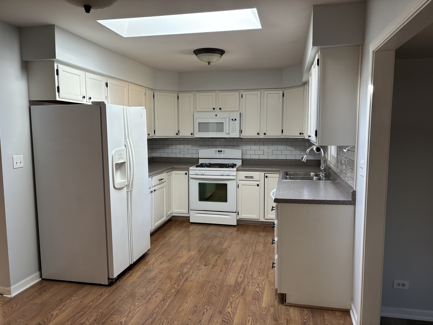 10 Briar Lane Geneva, IL 60134 - Photo 6 of 35 a kitchen with a refrigerator sink and cabinets