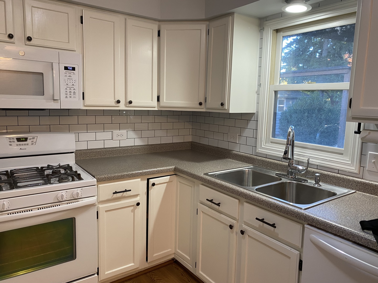 10 Briar Lane Geneva, IL 60134 - Photo 7 of 35 a kitchen with white cabinets and white appliances