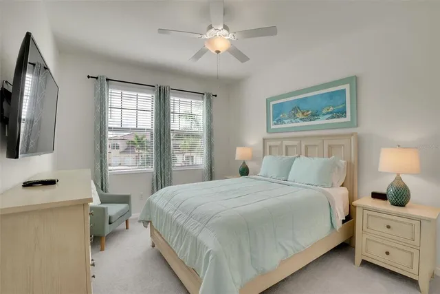a bedroom with a large bed and a flat tv screen on dresser