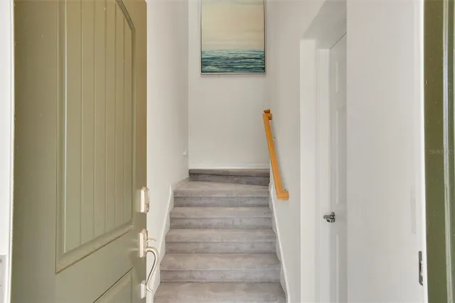 a view of staircase with white walls