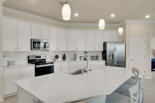 a kitchen with a sink stove and microwave