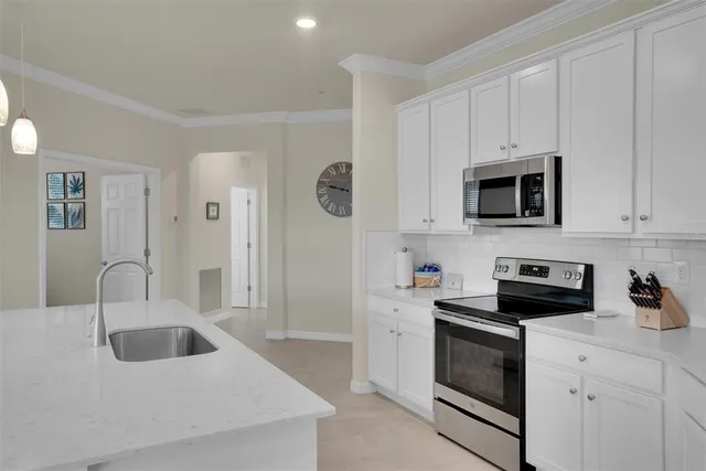 a kitchen with kitchen island cabinets and refrigerator