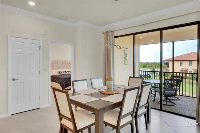 a dining room with furniture and large windows