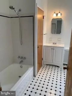 a bathroom with a bathtub sink and a mirror