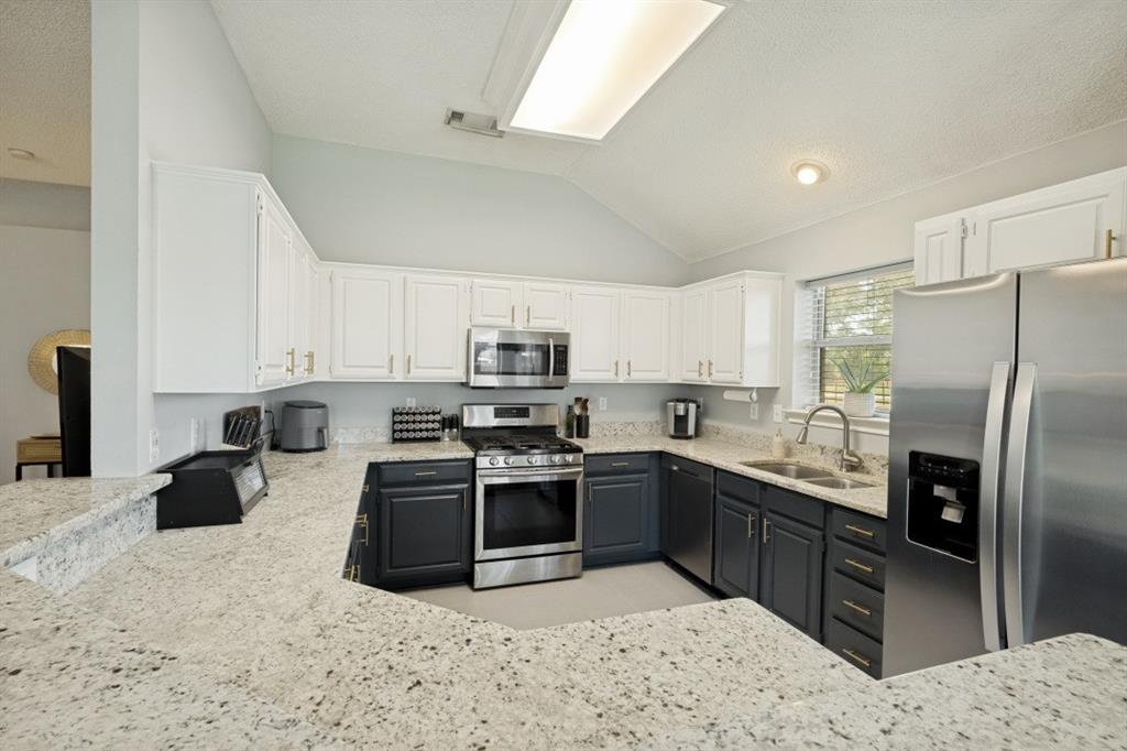 11709 Harbor Road Frisco, TX 75035 - Photo 6 of 12 a kitchen with stainless steel appliances granite countertop a sink stove refrigerator and cabinets