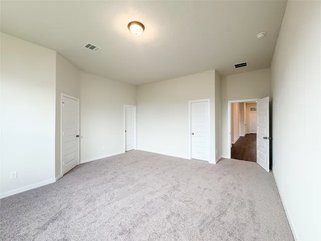 an empty room with a bathroom and sink