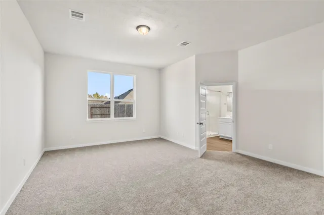 an empty room with a cabinet and mirrors