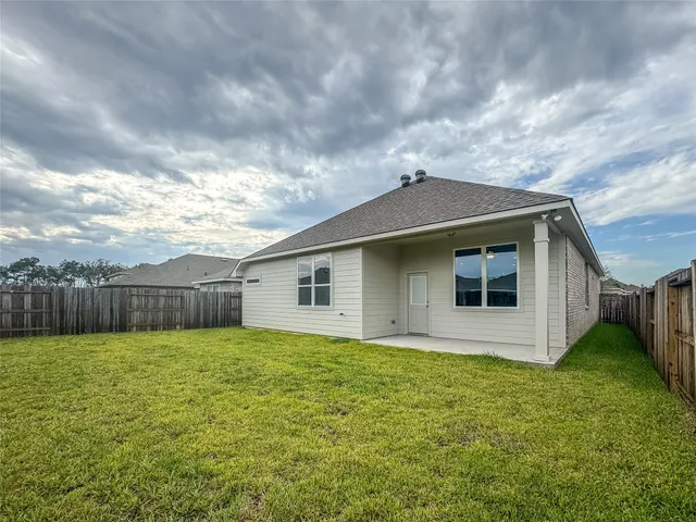 a view of a backyard with wooden fence