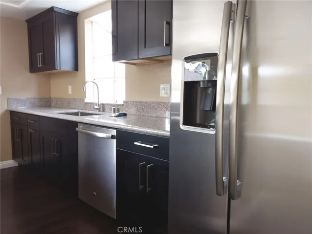 a kitchen with stainless steel appliances granite countertop cabinets and a granite counter top