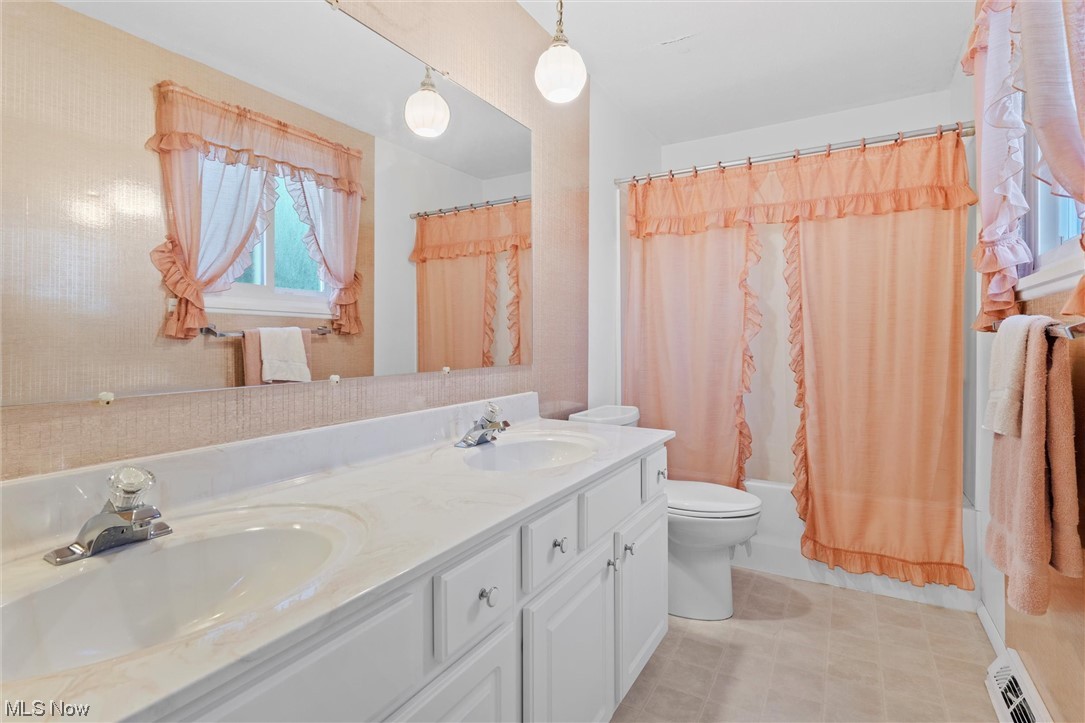 5624 Dolphin Road Mentor, OH 44060 - Photo 30 of 30 Bathroom featuring double large vanity, mirror, and light tile floors