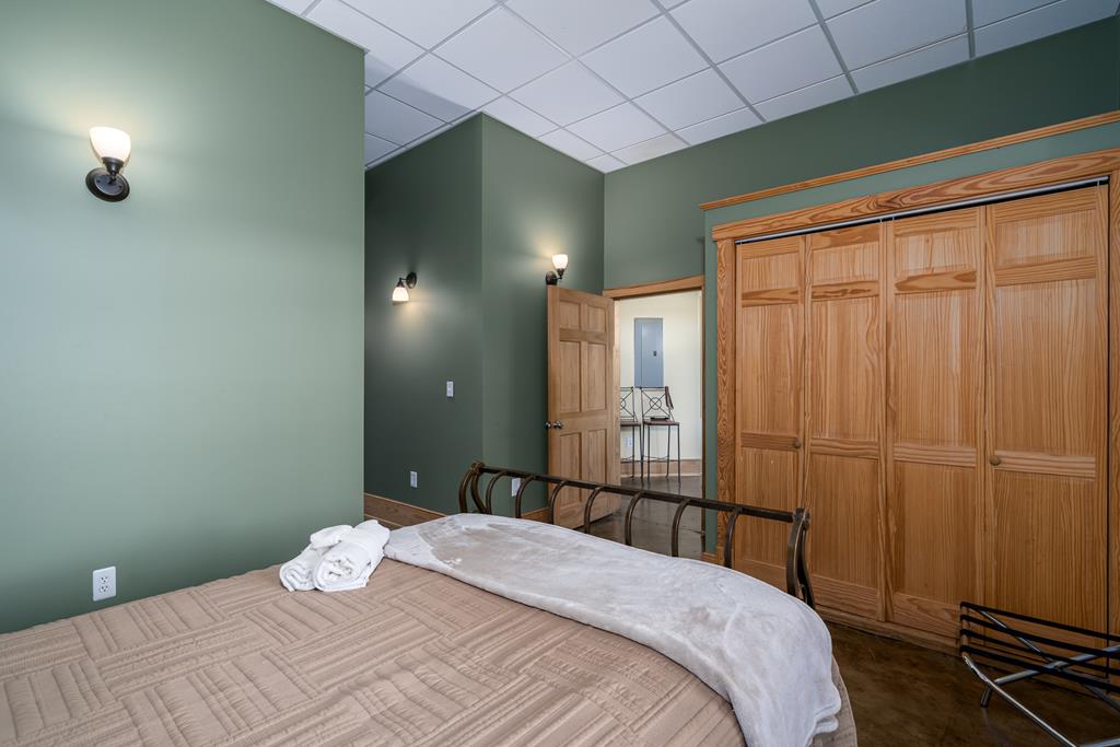 87 Riverview Lane Blue Ridge, GA 30513 - Photo 56 of 74 a bedroom with a bed and a chandelier