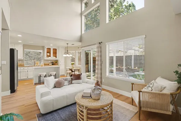 a kitchen with a refrigerator a stove a sink and dishwasher with wooden floor