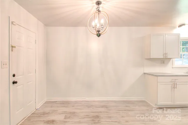 a view of kitchen with granite countertop window and sink