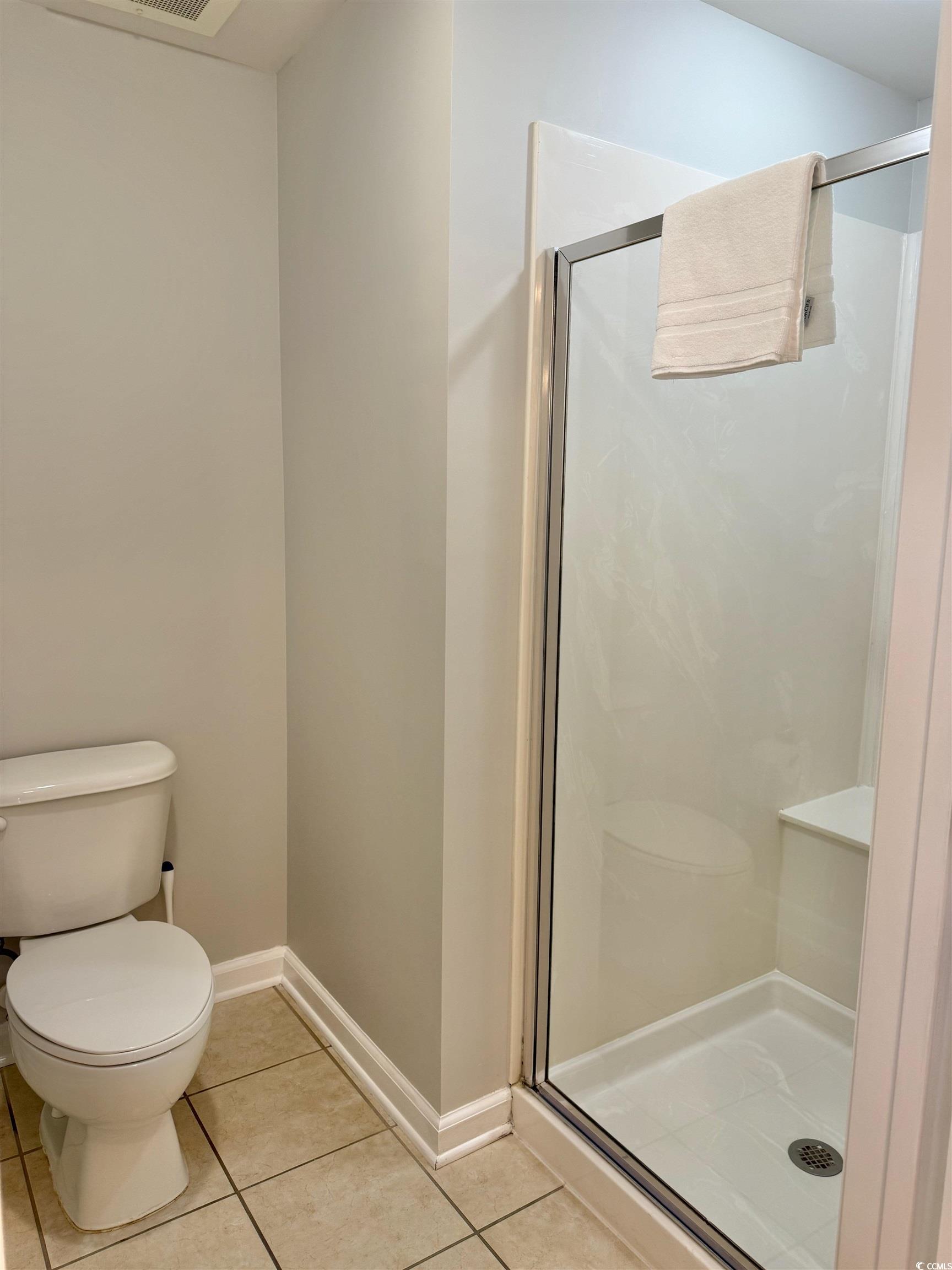 8500 Margate Circle, Unit 1108 Myrtle Beach, SC 29572 - Photo 18 of 40 Full bathroom with a stall shower and light tile patterned flooring