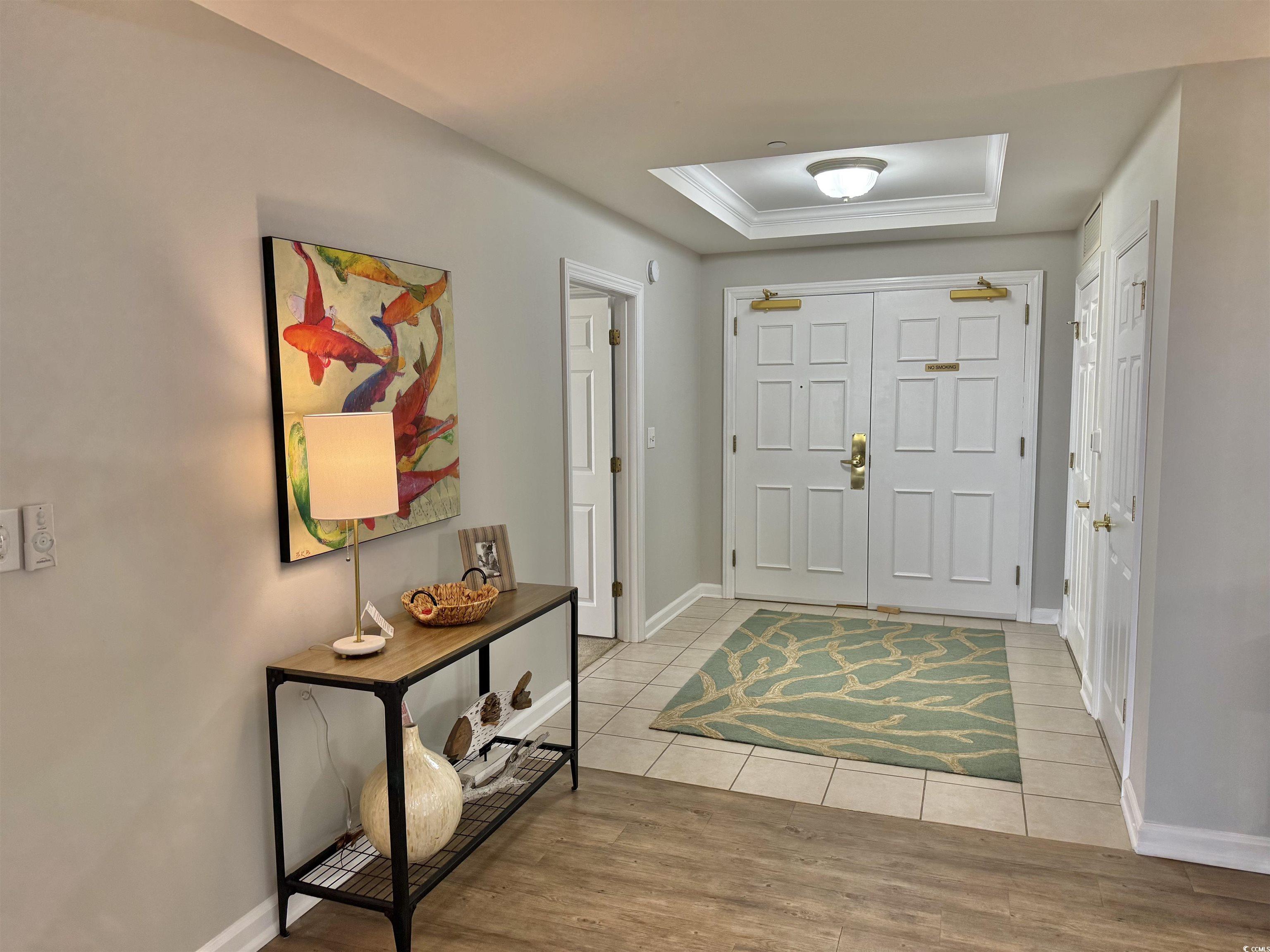 8500 Margate Circle, Unit 1108 Myrtle Beach, SC 29572 - Photo 2 of 40 Foyer with a raised ceiling, light wood-style floors, and crown molding