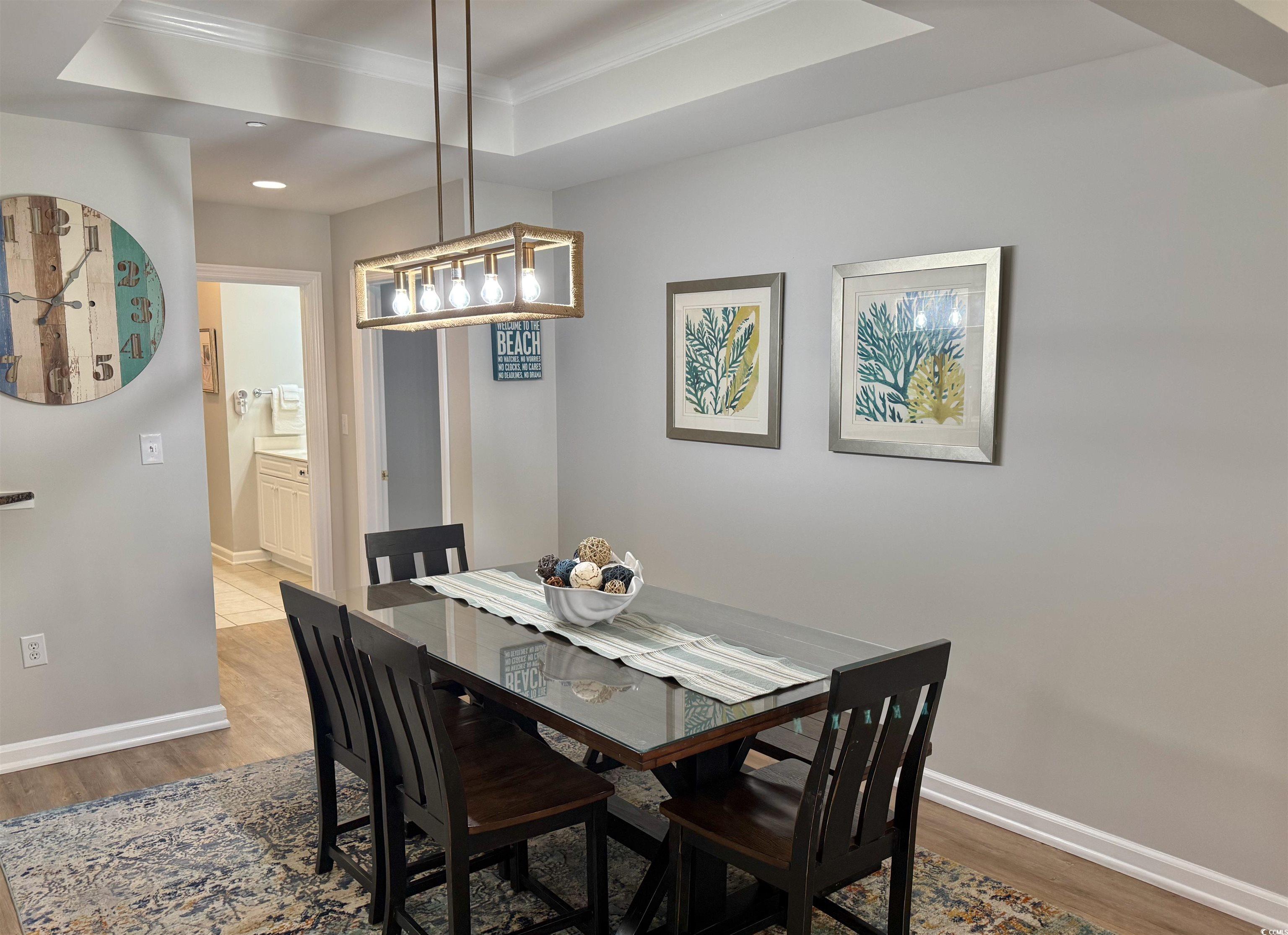 8500 Margate Circle, Unit 1108 Myrtle Beach, SC 29572 - Photo 26 of 40 Dining room featuring crown molding, light wood finished floors, and a raised ceiling