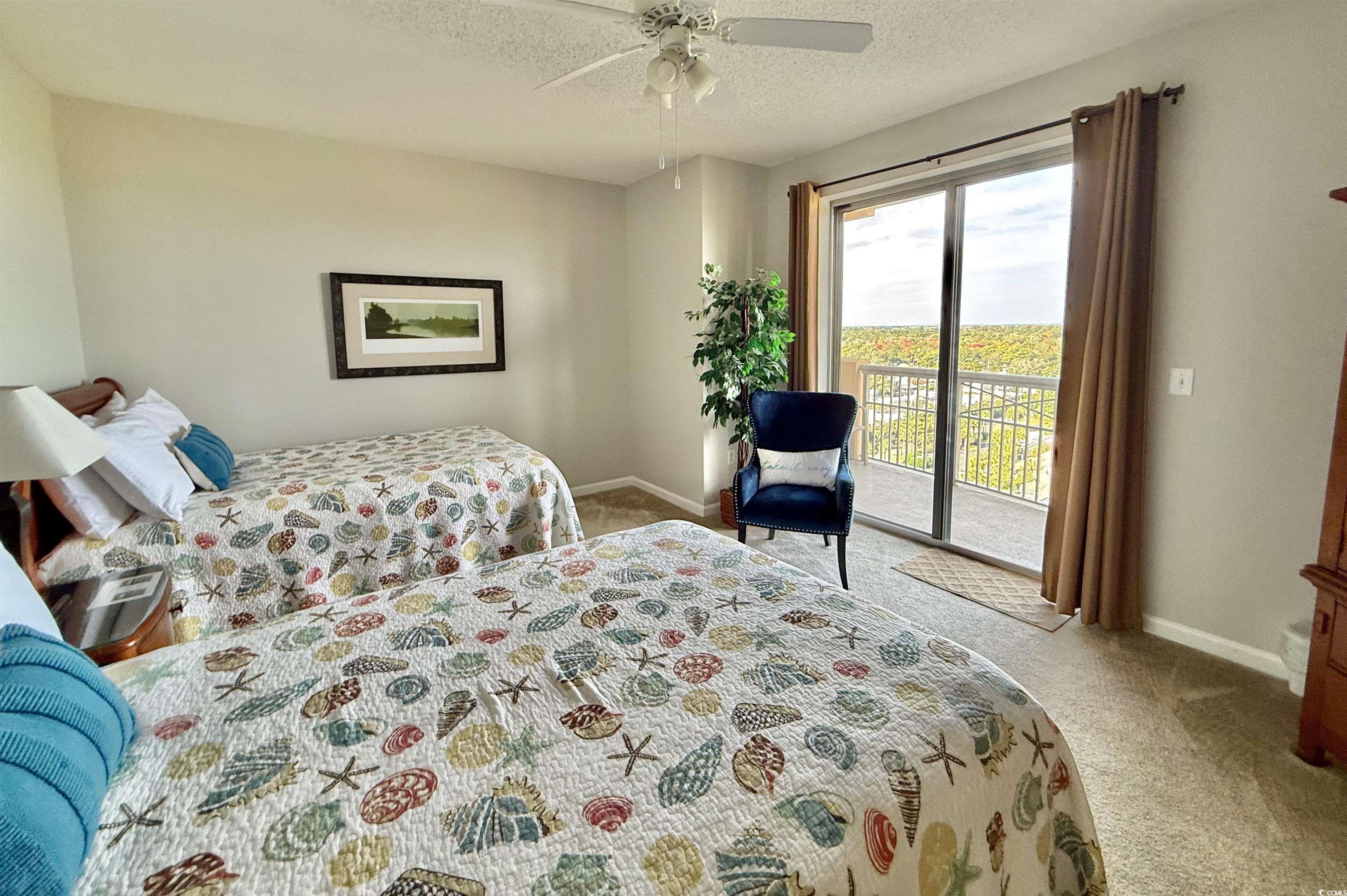 8500 Margate Circle, Unit 1108 Myrtle Beach, SC 29572 - Photo 30 of 40 Bedroom with carpet flooring, a textured ceiling, access to exterior, and ceiling fan