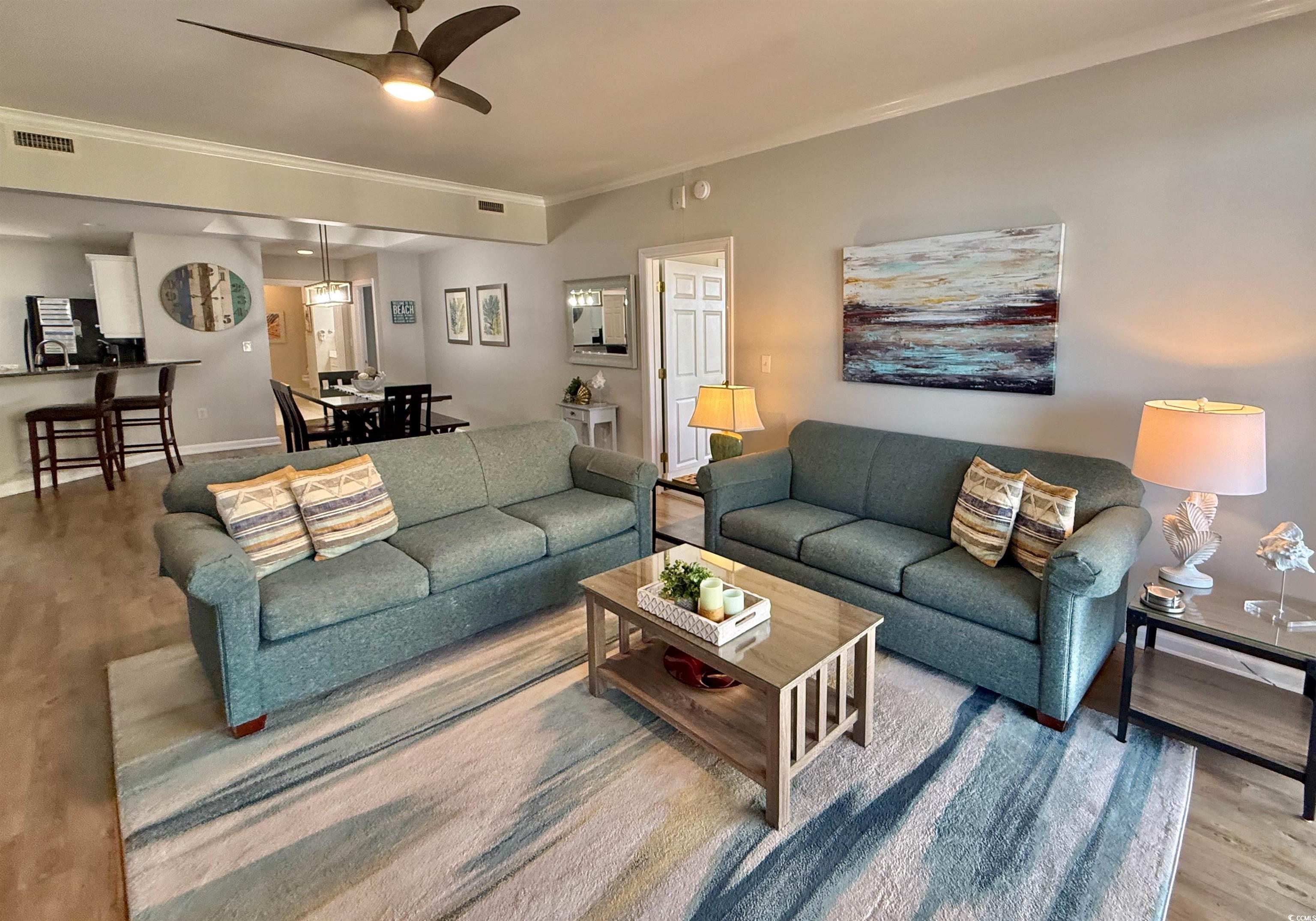 8500 Margate Circle, Unit 1108 Myrtle Beach, SC 29572 - Photo 10 of 40 Living room with wood finished floors, crown molding, and a ceiling fan