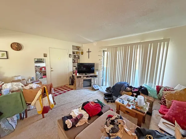 a bedroom with furniture and a flat screen tv