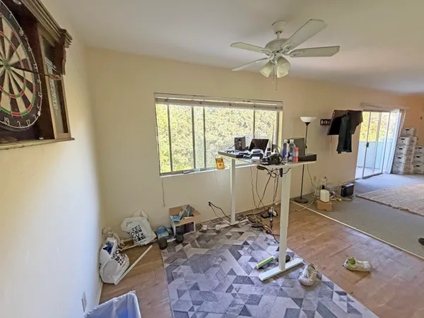 a view of a workspace with furniture and a window