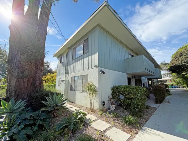 a backyard of a house with flower plants