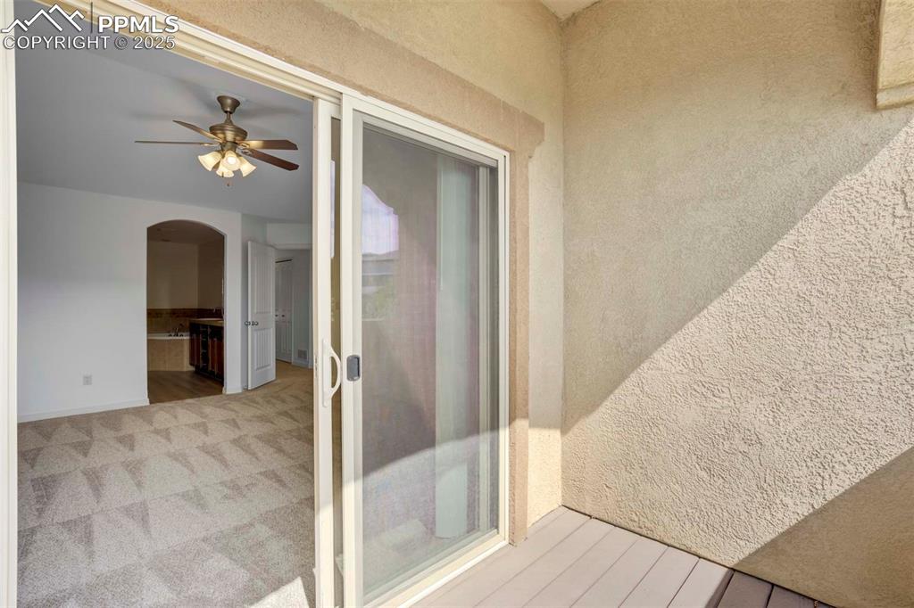 1571 Promontory Bluff View Colorado Springs, CO 80921 - Photo 24 of 49 a view of a hallway with wooden floor and staircase