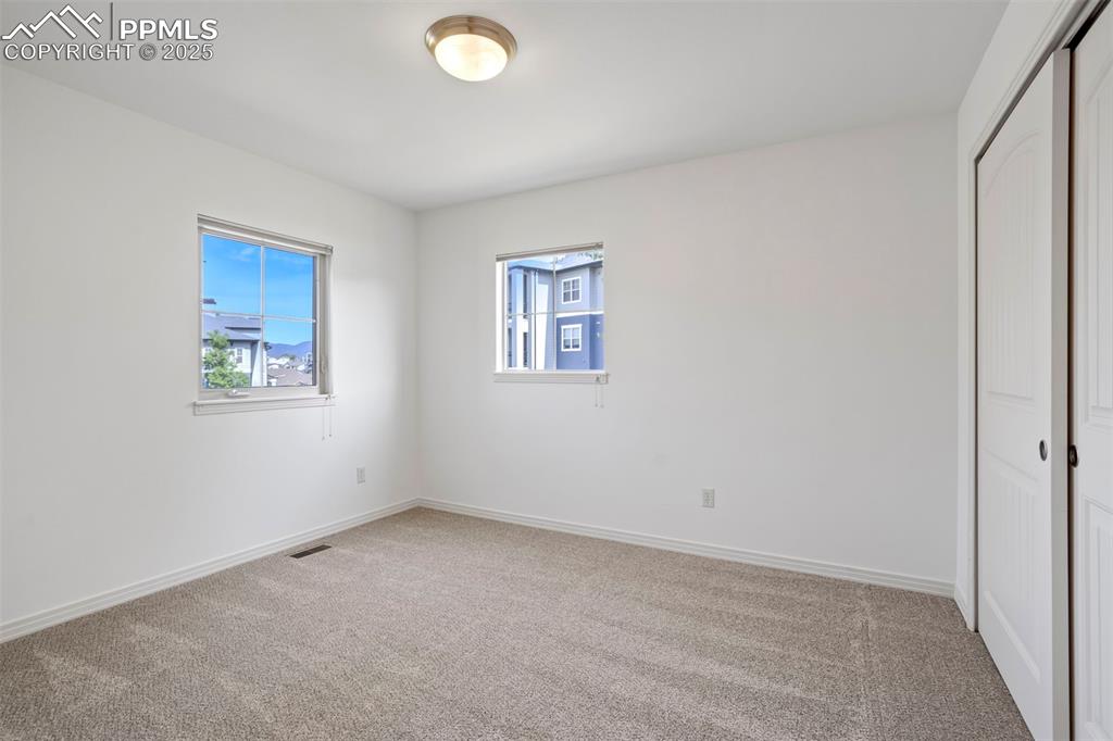 1571 Promontory Bluff View Colorado Springs, CO 80921 - Photo 25 of 49 an empty room with windows