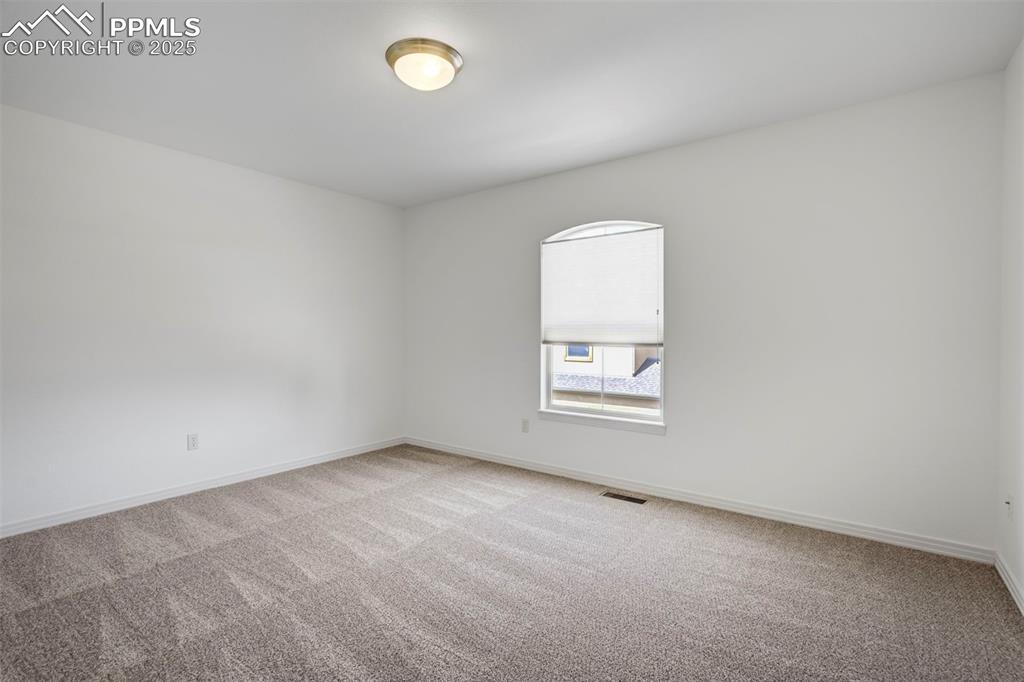 1571 Promontory Bluff View Colorado Springs, CO 80921 - Photo 29 of 49 an empty room with a window