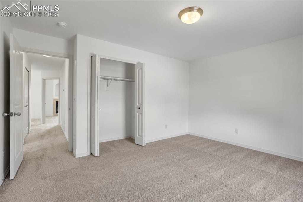 1571 Promontory Bluff View Colorado Springs, CO 80921 - Photo 30 of 49 an empty room with closet and windows
