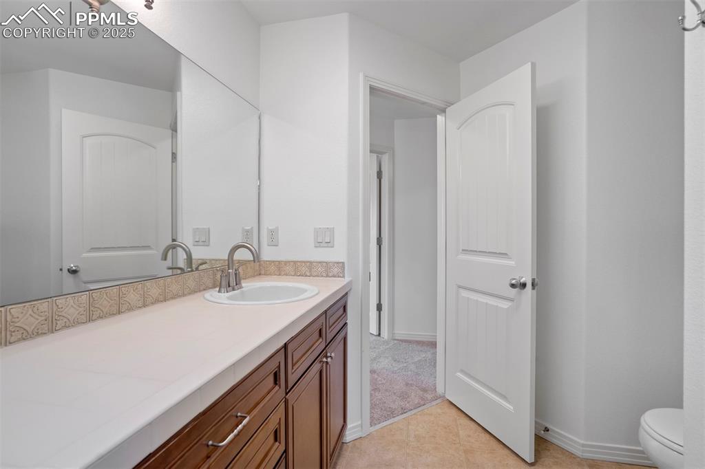 1571 Promontory Bluff View Colorado Springs, CO 80921 - Photo 32 of 49 a bathroom with a sink and a mirror