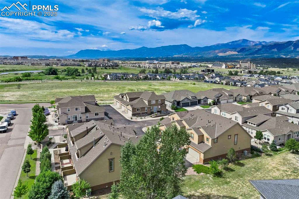 1571 Promontory Bluff View Colorado Springs, CO 80921 - Photo 44 of 49 an aerial view of a city with lots of residential buildings and mountain view in back