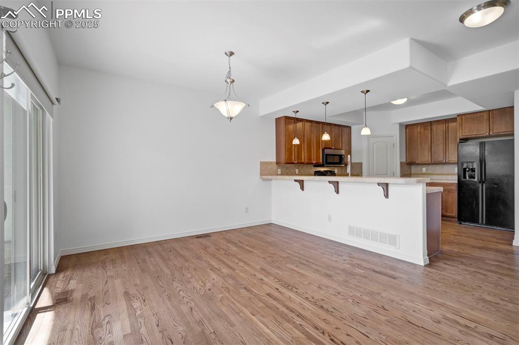 1571 Promontory Bluff View Colorado Springs, CO 80921 - Photo 48 of 49 a view of a kitchen with a sink and dishwasher wooden floor