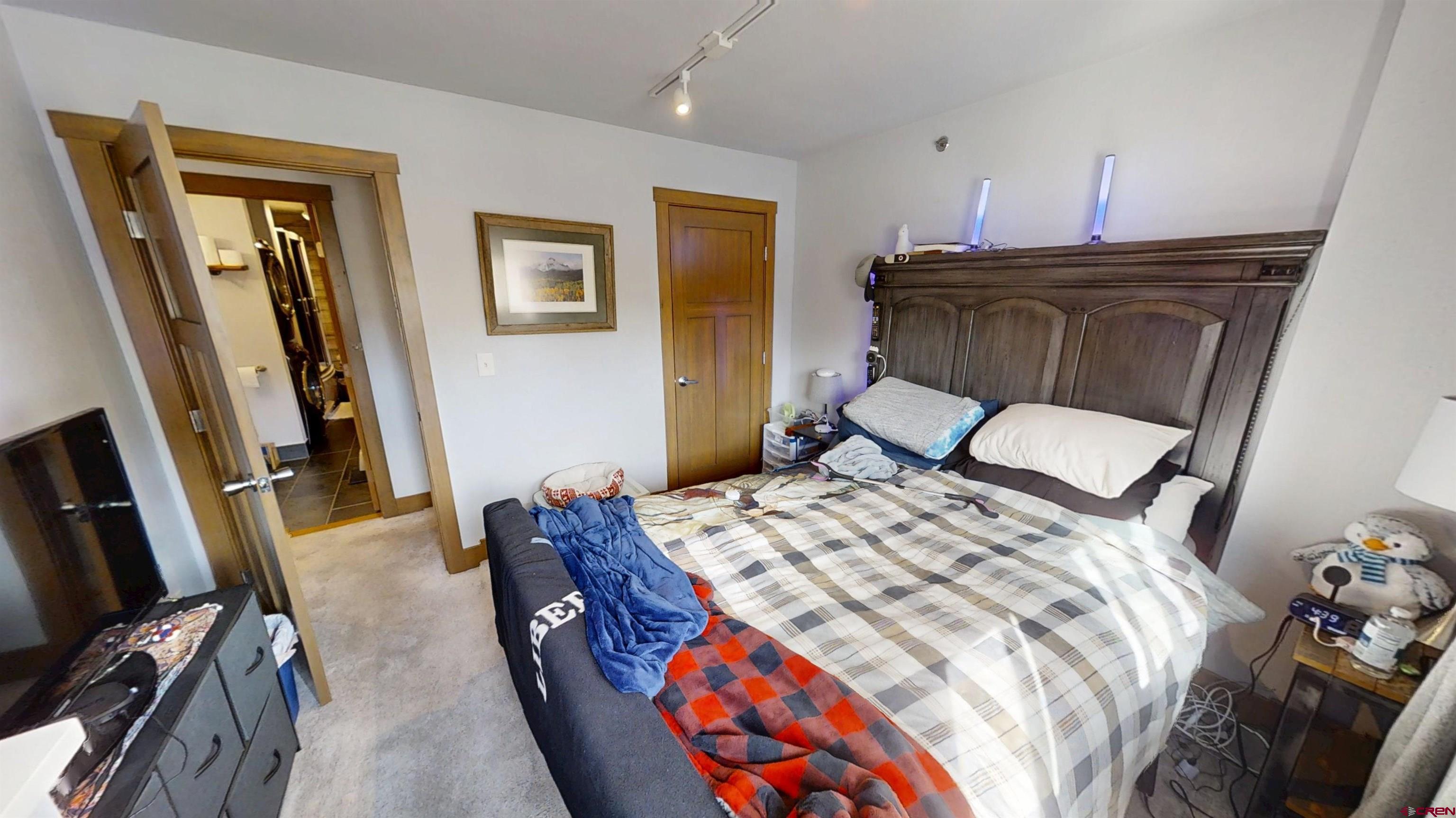 315 East 8th Avenue, Unit 203 Durango, CO 81301 - Photo 13 of 15 a bedroom with a bed and wooden floor
