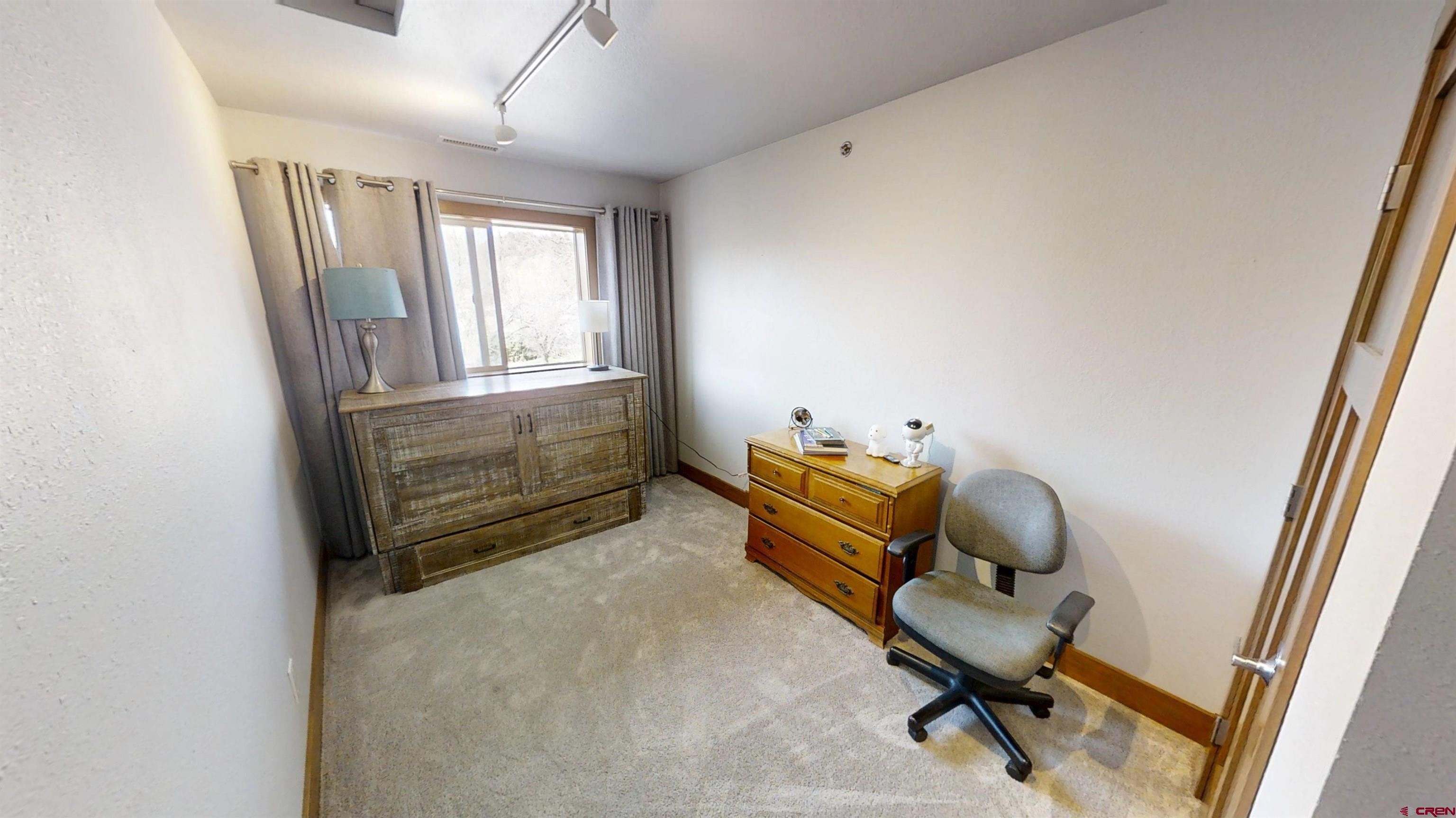 315 East 8th Avenue, Unit 203 Durango, CO 81301 - Photo 14 of 15 a room with chair and wooden floor