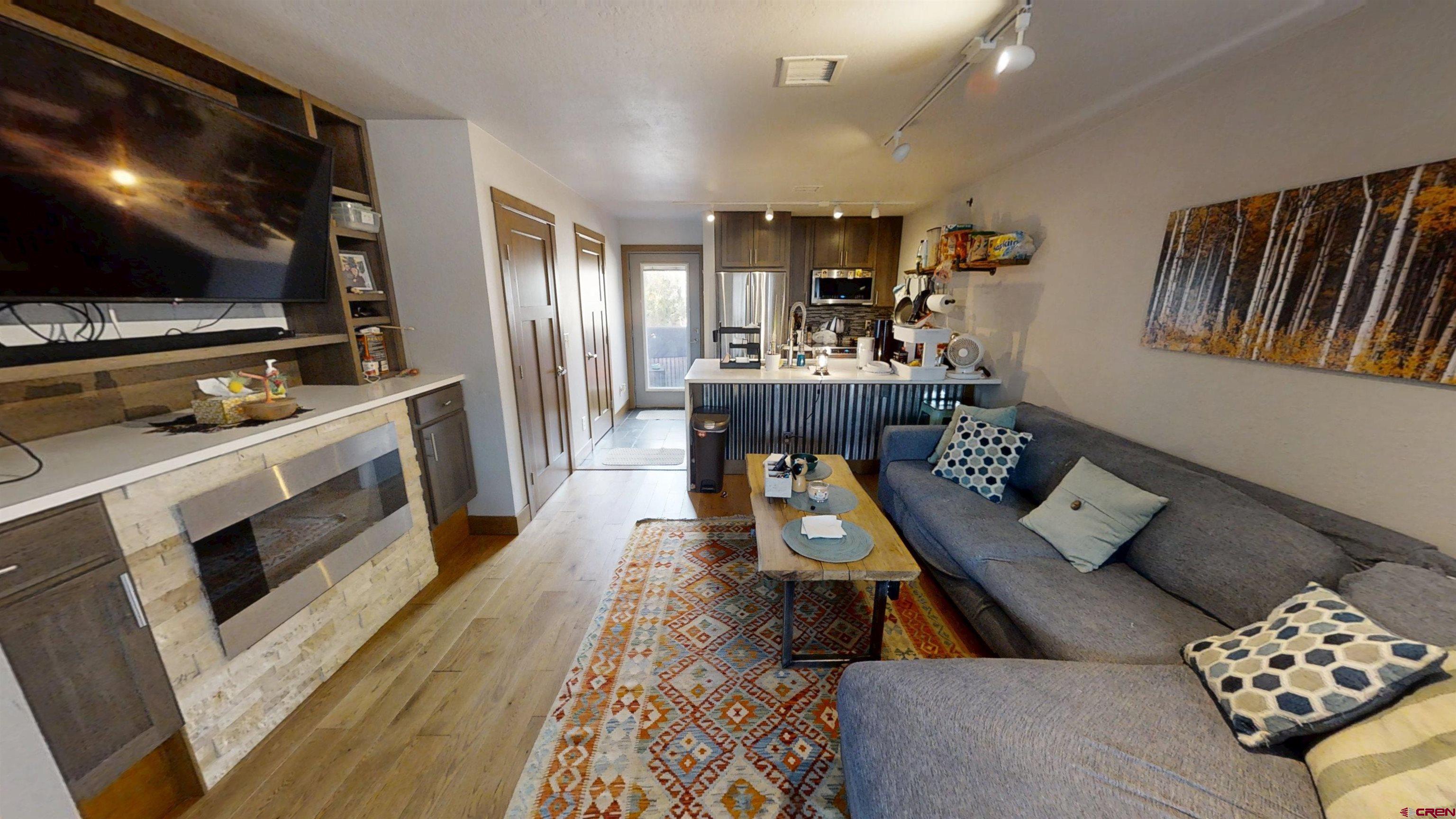 315 East 8th Avenue, Unit 203 Durango, CO 81301 - Photo 5 of 15 a living room with furniture and a flat screen tv