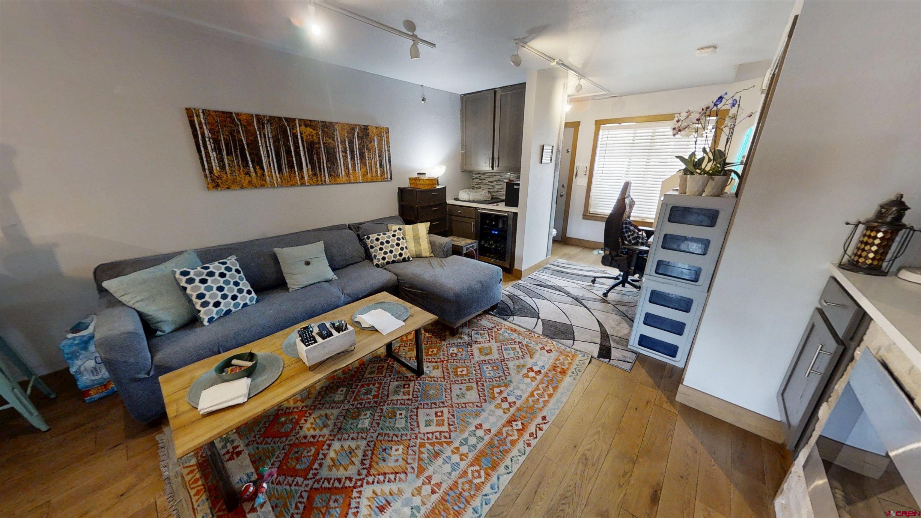 315 East 8th Avenue, Unit 203 Durango, CO 81301 - Photo 6 of 15 a living room with furniture and a wooden floor