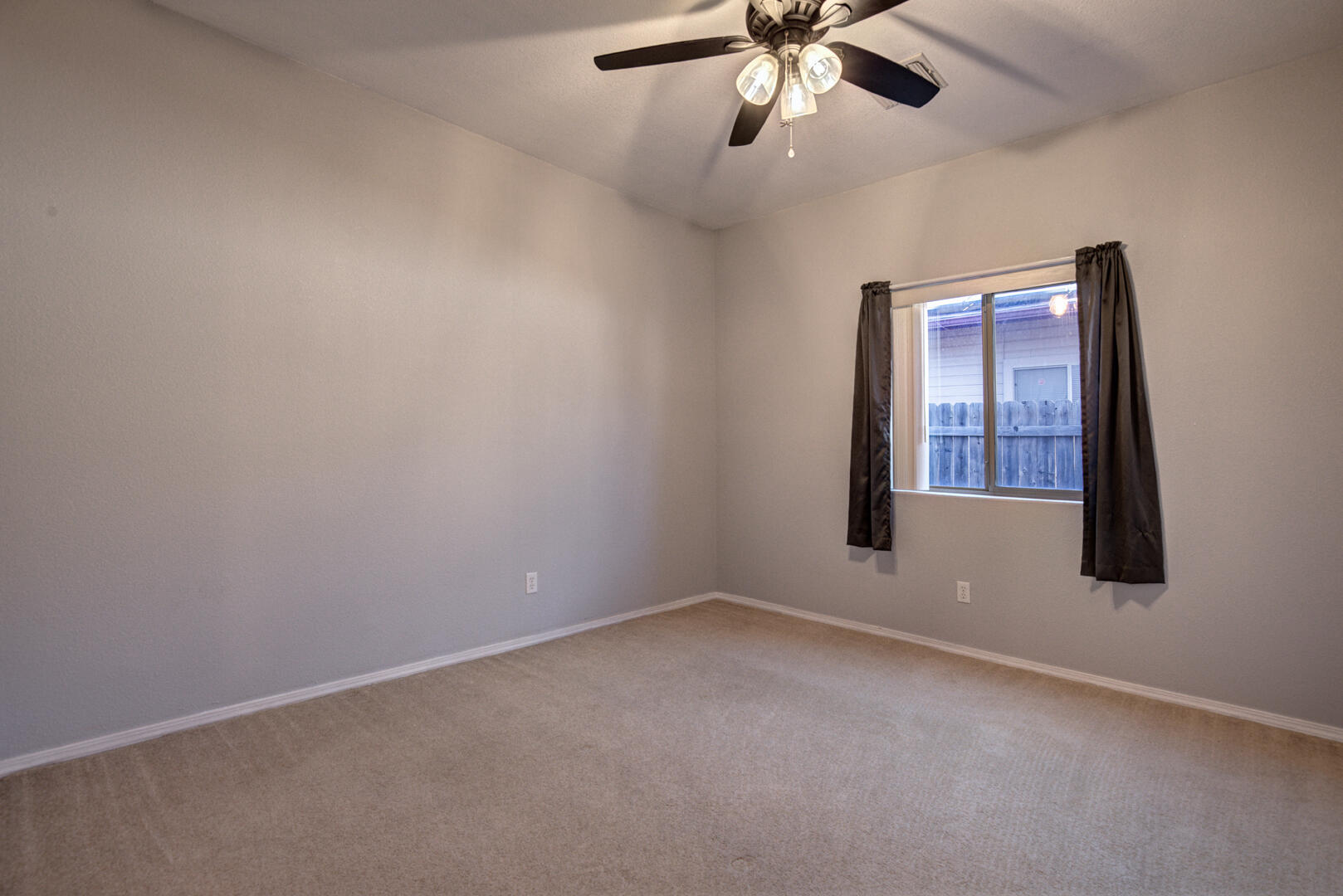 334 East Cedar Mill Road Star Valley, AZ 85541 - Photo 22 of 32 en empty room with windows and fan