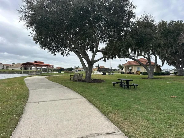 a view of a building with patio and swimming pool