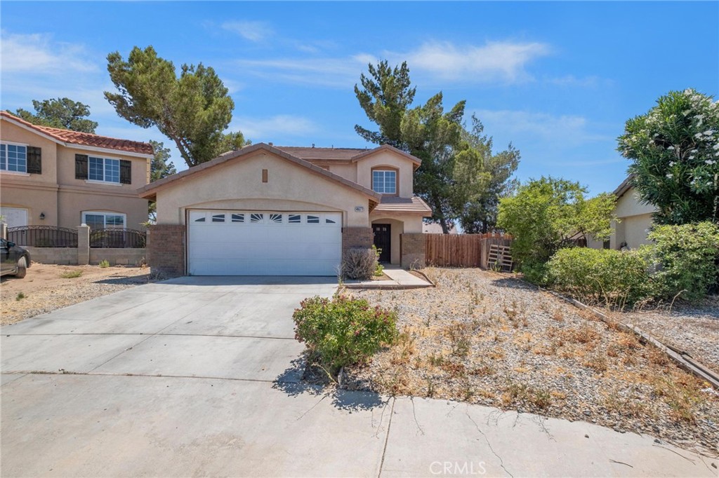 14677 Foothill Road Victorville, CA 92394 - Photo 1 of 1 a front view of a building with garden