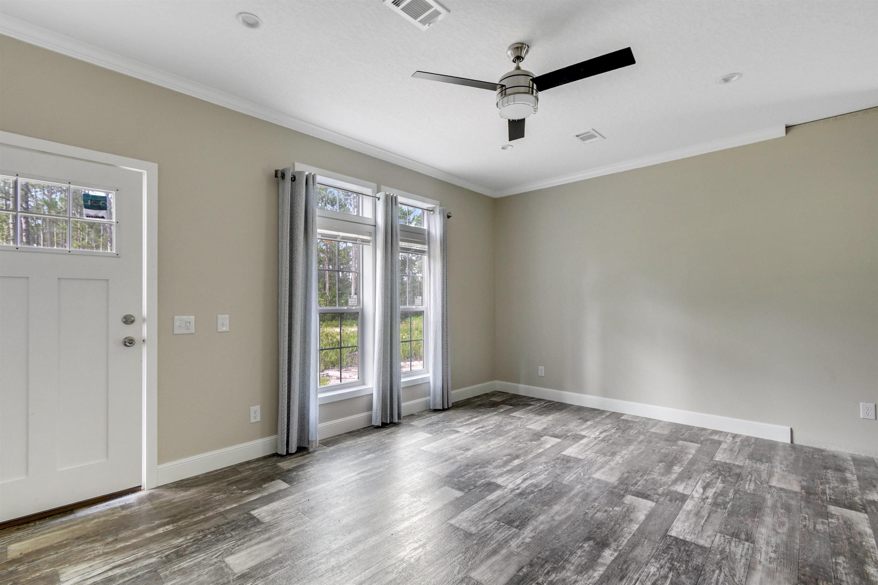 4240 Isaac Street Hastings, FL 32145 - Photo 12 of 19 Spare room with crown molding, wood finished floors, and ceiling fan