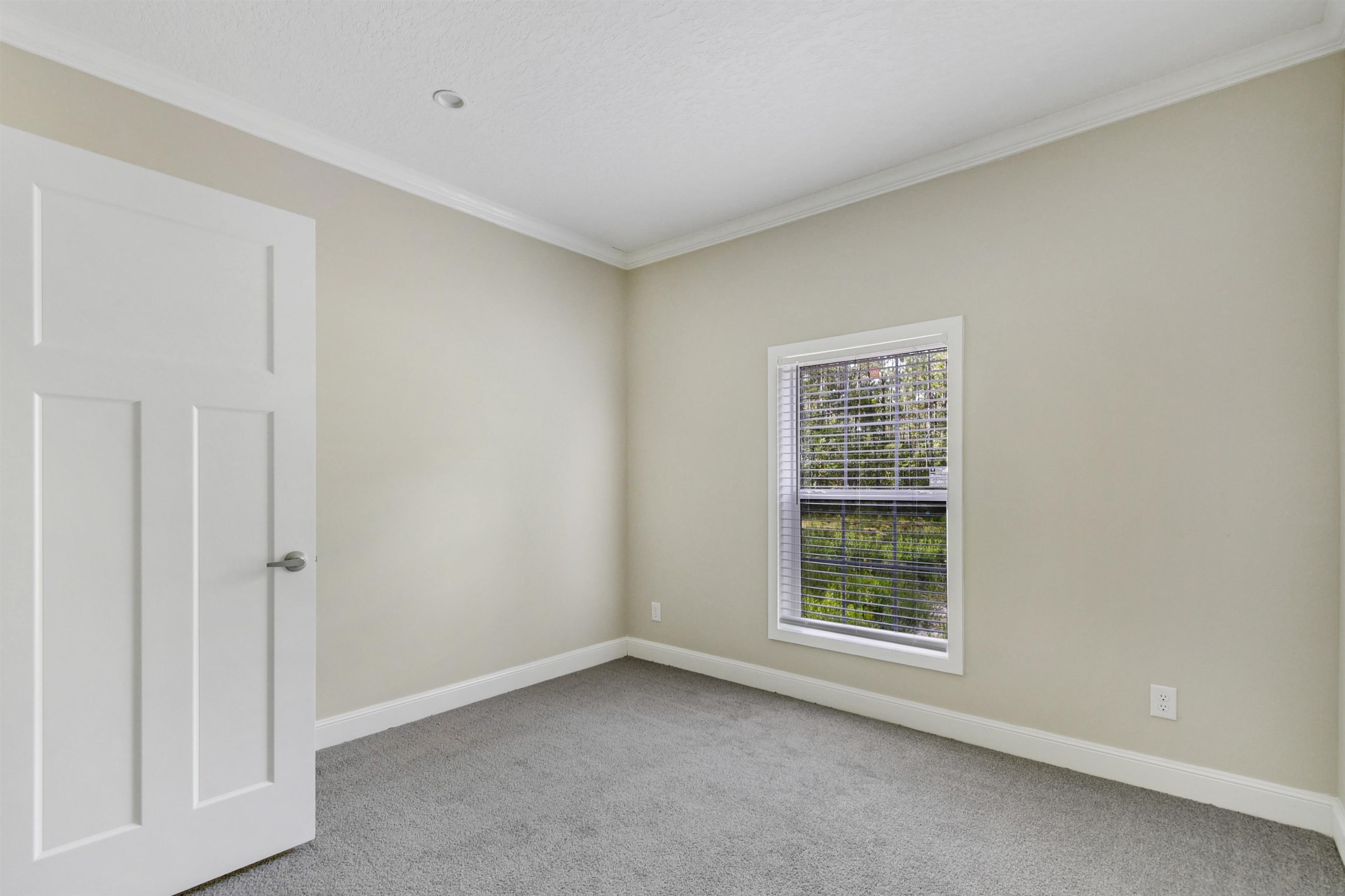 4240 Isaac Street Hastings, FL 32145 - Photo 7 of 19 Empty room with ornamental molding and light colored carpet