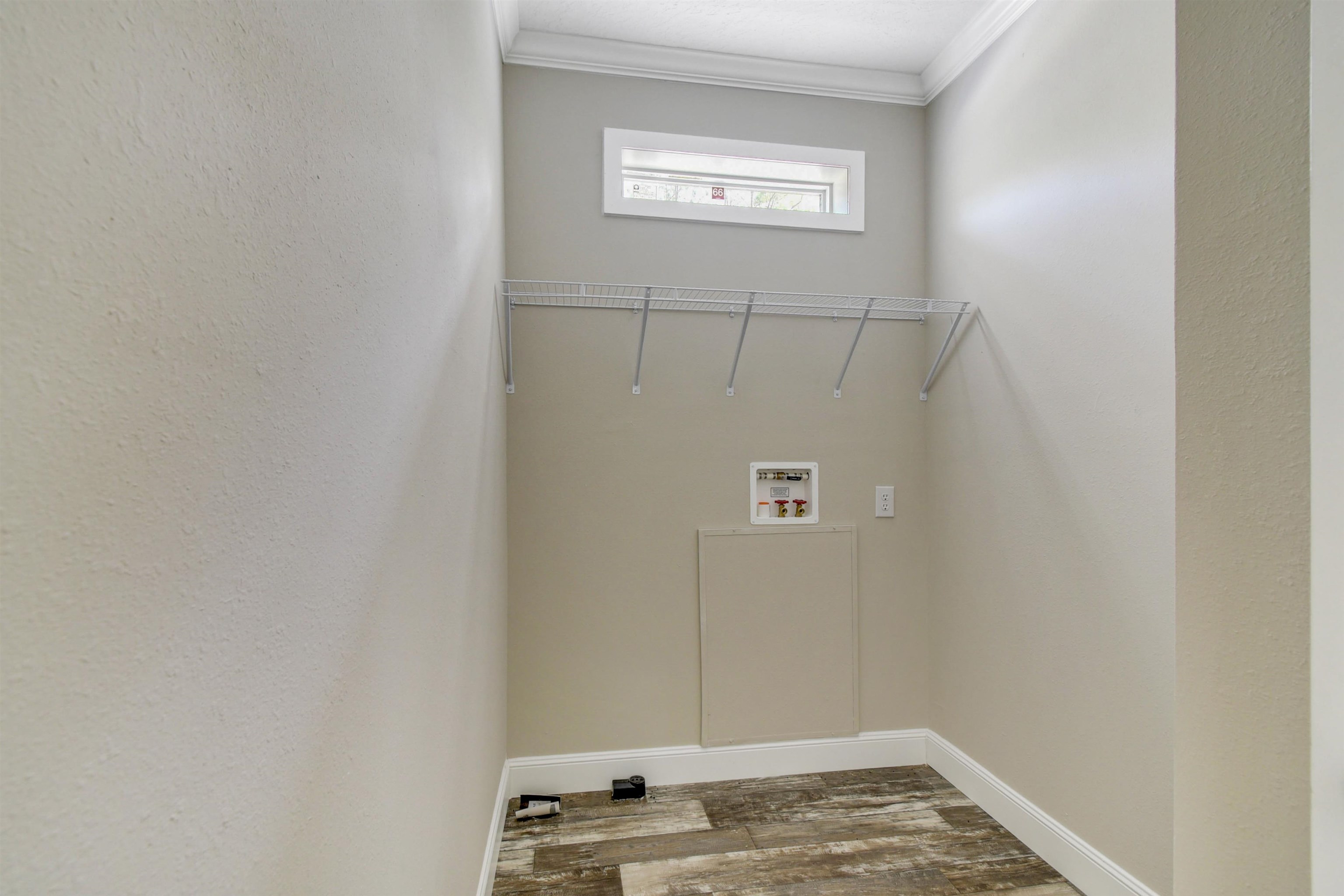 4240 Isaac Street Hastings, FL 32145 - Photo 8 of 19 Laundry area featuring wood finished floors, ornamental molding, and washer hookup