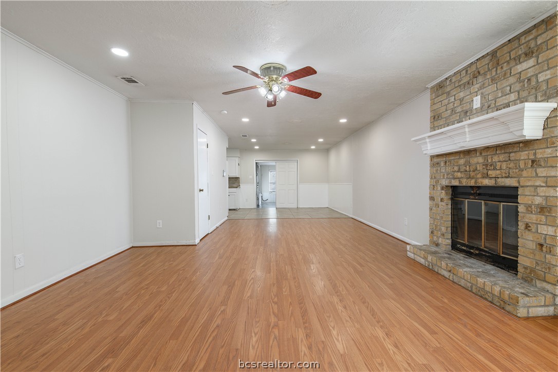 4403 Robinhood Circle Bryan, TX 77803 - Photo 3 of 19 a view of an empty room with wooden floor and a fireplace