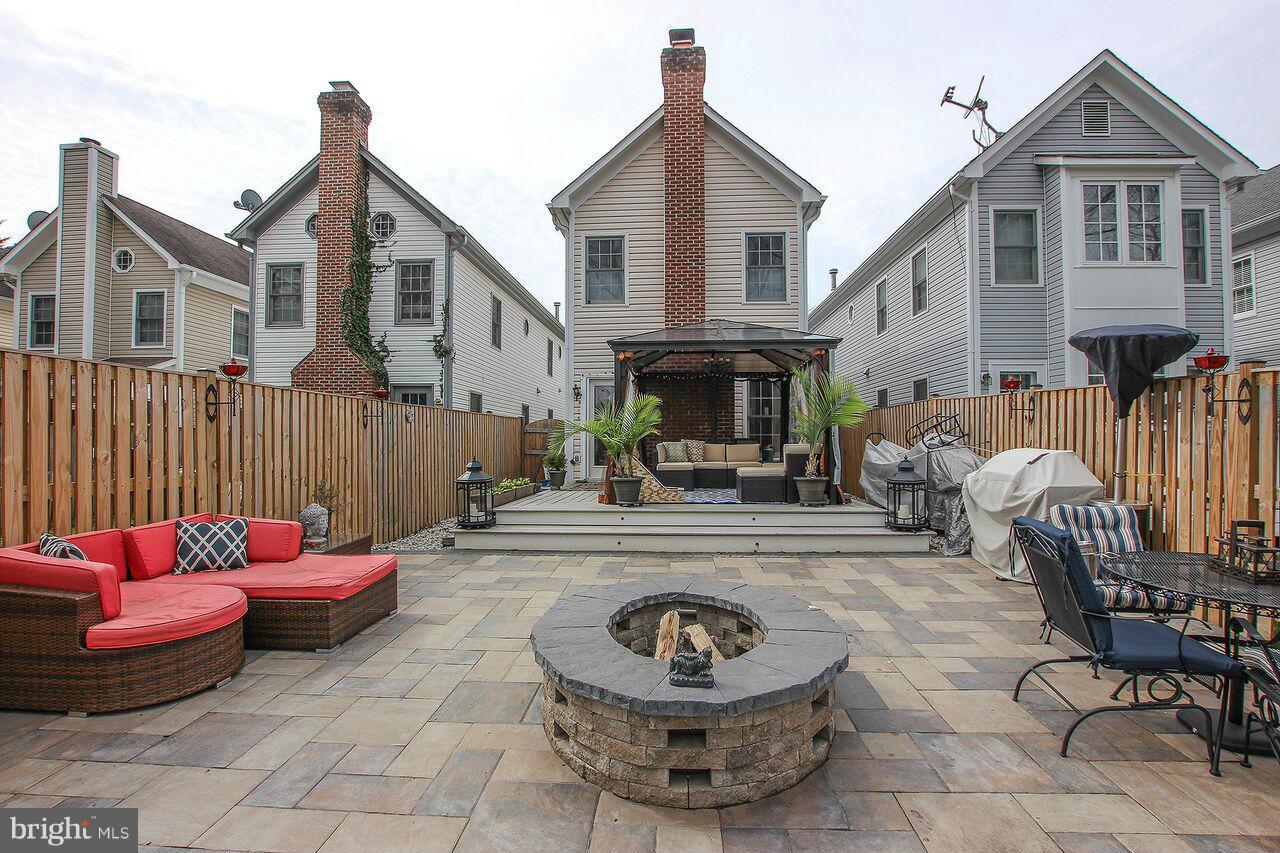 a view of a house with a patio and a fire pit